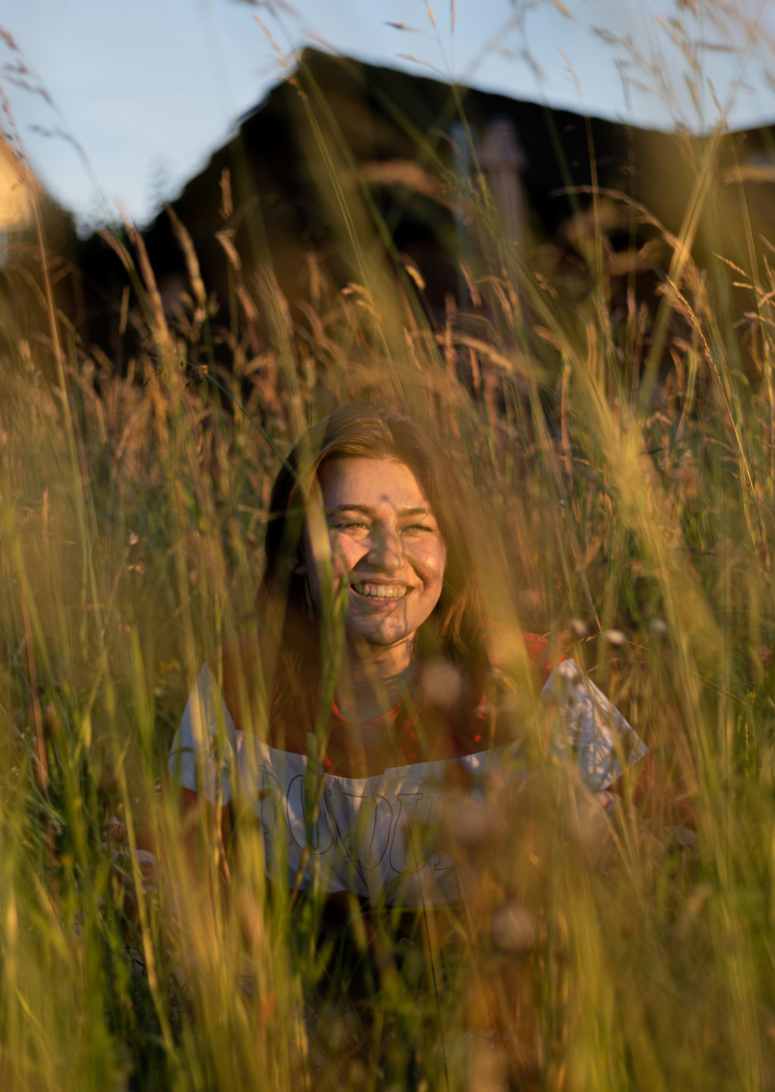 woman in white long sleeve shirt on green grass field during daytime